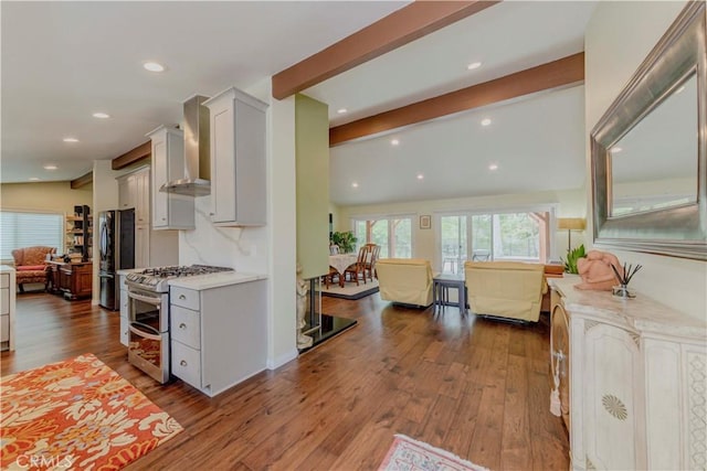 5276 Willow Wood Rd, Rolling Hills Estates, CA 90274 - kitchen with range with two ovens, light countertops, freestanding refrigerator, wall chimney exhaust hood, and dark wood-style floors