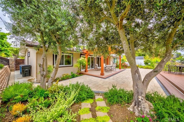 5276 Willow Wood Rd, Rolling Hills Estates, CA 90274 - rear view of property featuring outdoor dining space, a patio, stucco siding, and a deck