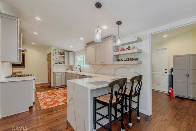 5276 Willow Wood Rd, Rolling Hills Estates, CA 90274 - kitchen with open shelves, a peninsula, dark wood-type flooring, backsplash, and a breakfast bar area