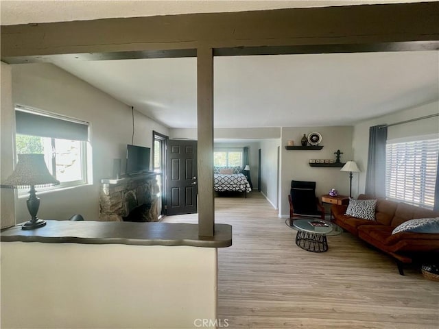2226 Evans Dr, Arrowbear, CA 92382 - living area with light wood-style floors and a stone fireplace