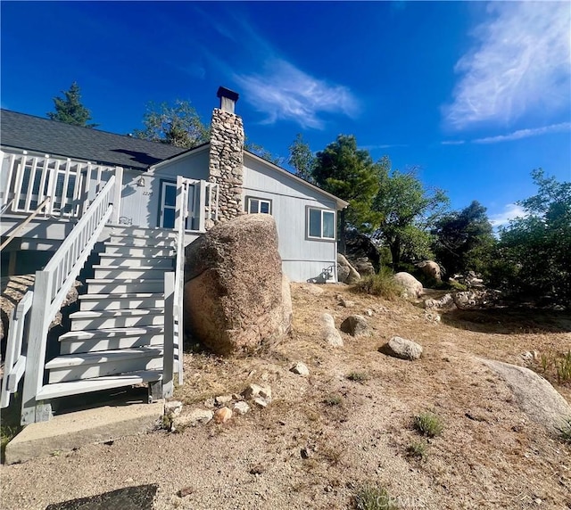 2226 Evans Dr, Arrowbear, CA 92382 - view of home's exterior featuring a chimney and stairs