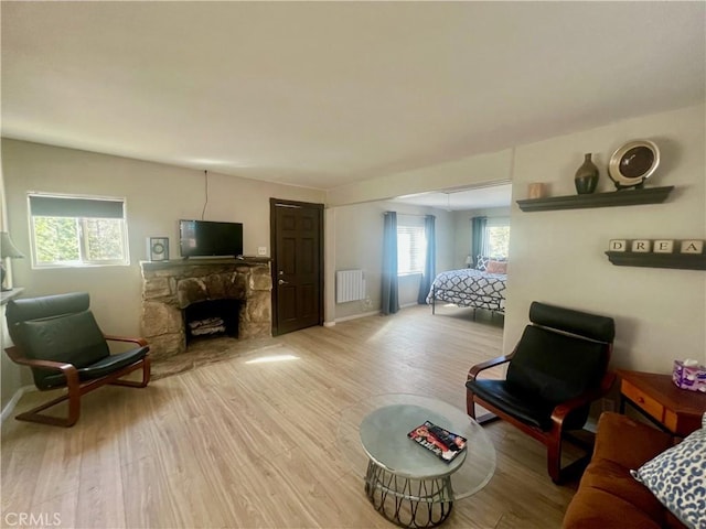 2226 Evans Dr, Arrowbear, CA 92382 - living area featuring a fireplace, wood finished floors, and radiator heating unit