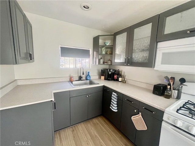 2226 Evans Dr, Arrowbear, CA 92382 - kitchen featuring light wood-type flooring, white appliances, glass insert cabinets, light countertops, and open shelves
