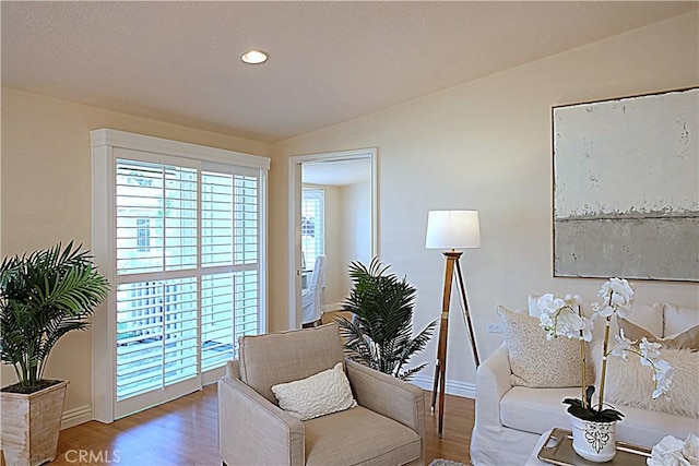 1681 Tam Oshanter Rd Unit 10C M12, Seal Beach, CA 90740 - sitting room featuring wood finished floors, vaulted ceiling, and recessed lighting