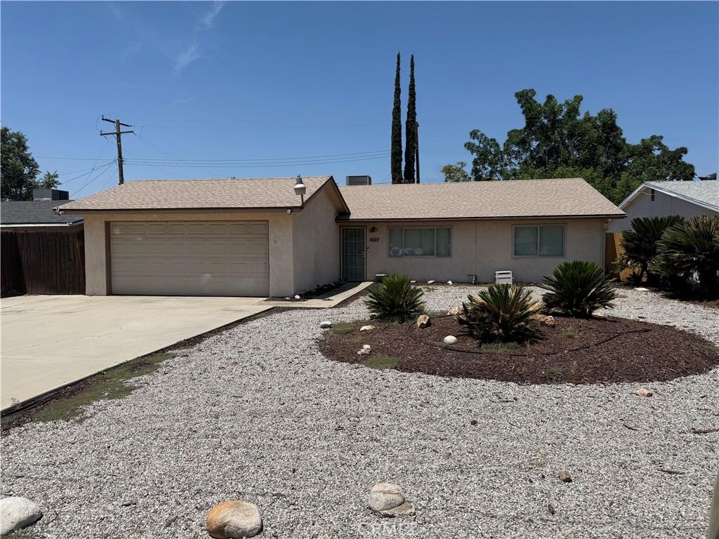 7774 Drummond Ave, Highland, CA 92346 - ranch-style house featuring concrete driveway, a garage, and stucco siding