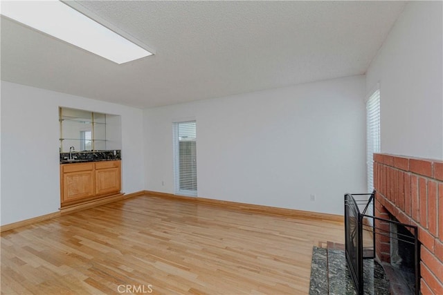 2406 Descanso Way, Torrance, CA 90504 - unfurnished living room featuring light wood-type flooring and a fireplace