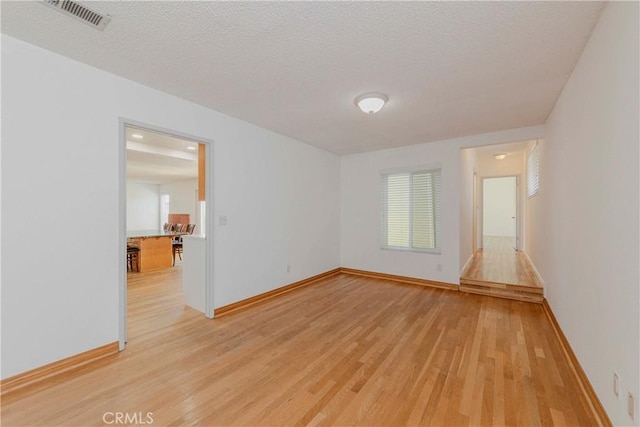 2406 Descanso Way, Torrance, CA 90504 - spare room with light wood finished floors and a textured ceiling