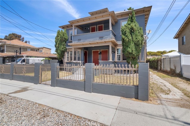 1241 W 22nd St, Los Angeles, CA 90007 - view of front of house featuring a balcony, a fenced front yard, a gate, and a porch