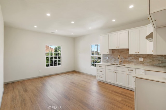 1241 W 22nd St, Los Angeles, CA 90007 - kitchen with light countertops, light wood finished floors, backsplash, and recessed lighting