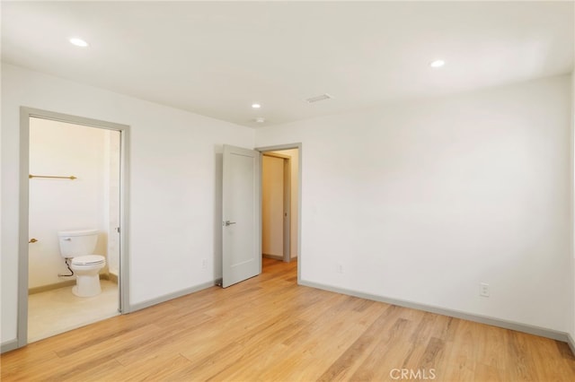 1241 W 22nd St, Los Angeles, CA 90007 - unfurnished bedroom featuring light wood-type flooring, recessed lighting, and connected bathroom