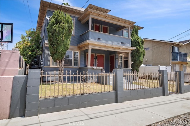 1241 W 22nd St, Los Angeles, CA 90007 - view of front of house featuring a balcony, covered porch, a fenced front yard, and a gate
