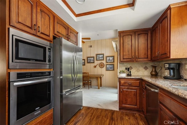 27815 Sheffield, Mission Viejo, CA 92692 - kitchen featuring appliances with stainless steel finishes, light stone countertops, dark wood-type flooring, ornamental molding, and a raised ceiling