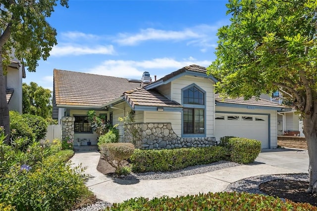 27815 Sheffield, Mission Viejo, CA 92692 - view of front facade with a tile roof, stone siding, concrete driveway, and a garage