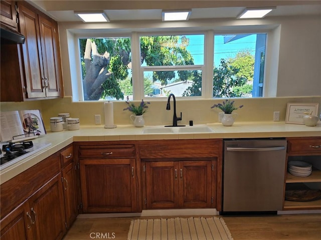 24921 Cypress St, Lomita, CA 90717 - kitchen featuring dishwasher, white gas stovetop, light wood-type flooring, and brown cabinets