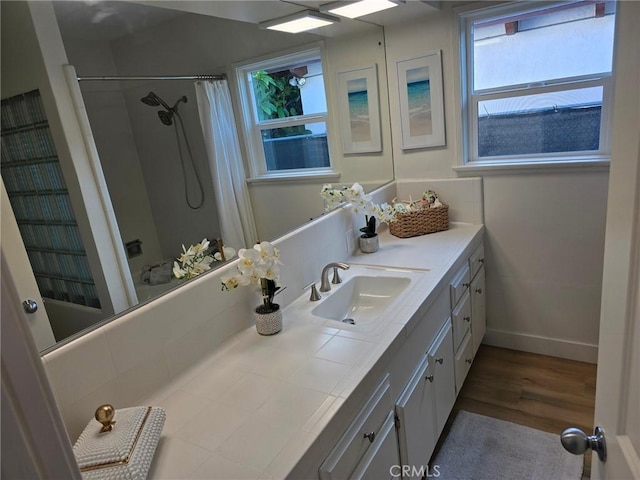 24921 Cypress St, Lomita, CA 90717 - bathroom with vanity, wood finished floors, and shower / tub combo