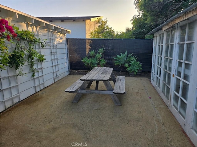 24921 Cypress St, Lomita, CA 90717 - patio terrace at dusk with a patio area, a fenced backyard, and outdoor dining area