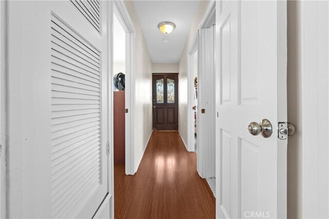 1067 N Wilton Pl, Los Angeles, CA 90038 - hall featuring dark wood-style flooring and baseboards