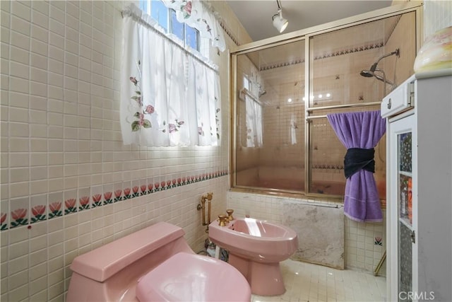 1067 N Wilton Pl, Los Angeles, CA 90038 - bathroom featuring a bidet, tile walls, and tiled shower / bath combo