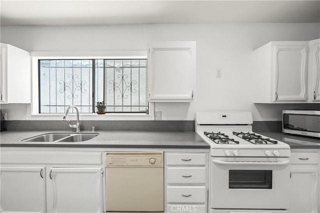1067 N Wilton Pl, Los Angeles, CA 90038 - kitchen featuring white appliances, white cabinetry, and dark countertops