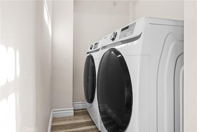 1067 N Wilton Pl, Los Angeles, CA 90038 - laundry area with separate washer and dryer and wood finished floors