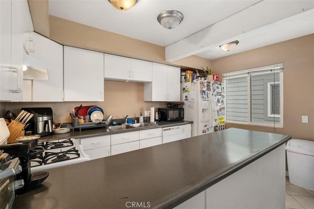 34055 Silver Lantern St, Dana Point, CA 92629 - kitchen featuring white appliances, dark countertops, white cabinetry, a peninsula, and light tile patterned floors