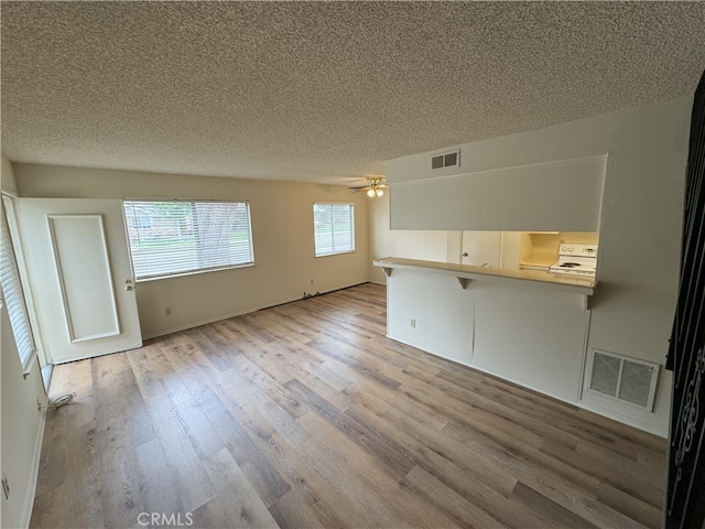 3078 Winfield Ave, La Verne, CA 91750 - unfurnished living room featuring a textured ceiling, wood finished floors, and ceiling fan