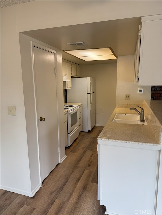 3078 Winfield Ave, La Verne, CA 91750 - kitchen with white appliances, wood finished floors, light countertops, under cabinet range hood, and white cabinets