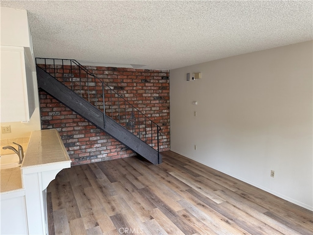 3078 Winfield Ave, La Verne, CA 91750 - unfurnished living room with a textured ceiling and wood finished floors