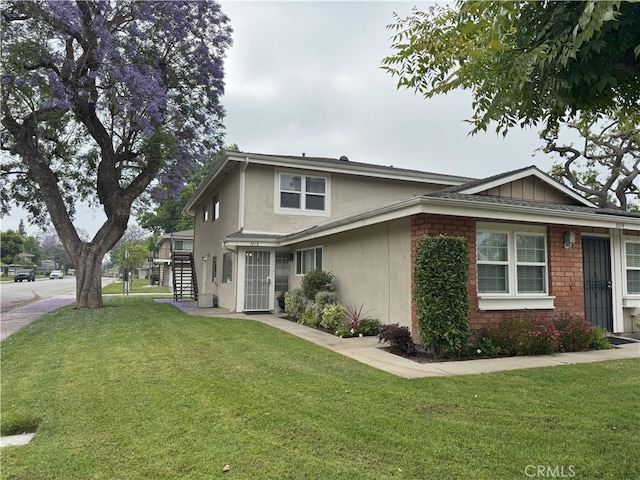 3078 Winfield Ave, La Verne, CA 91750 - view of home's exterior with a yard, stucco siding, and stairway