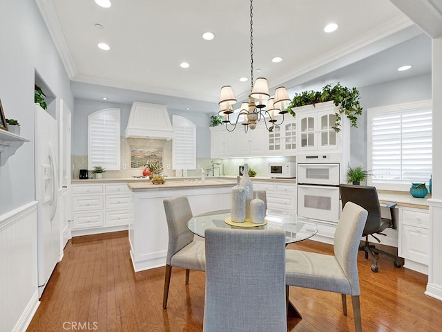 12272 Media Panorama, North Tustin, CA 92705 - dining space featuring a chandelier, ornamental molding, wood finished floors, recessed lighting, and a desk