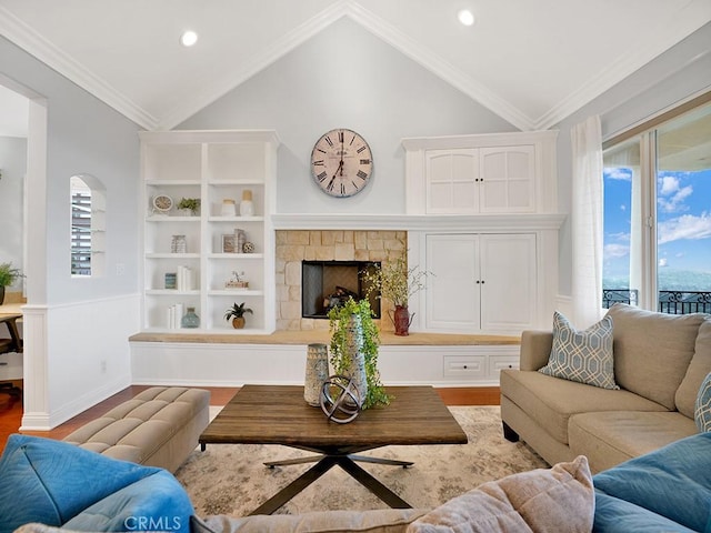 12272 Media Panorama, North Tustin, CA 92705 - living area featuring lofted ceiling, wood finished floors, a stone fireplace, recessed lighting, and crown molding