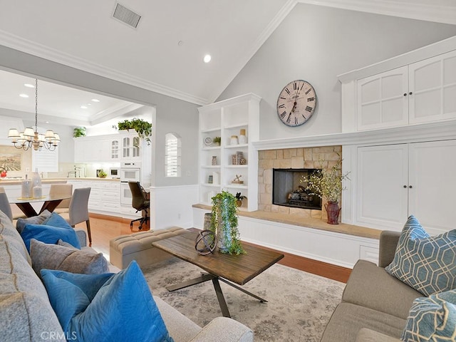 12272 Media Panorama, North Tustin, CA 92705 - living area featuring wood finished floors, a chandelier, recessed lighting, a fireplace, and high vaulted ceiling