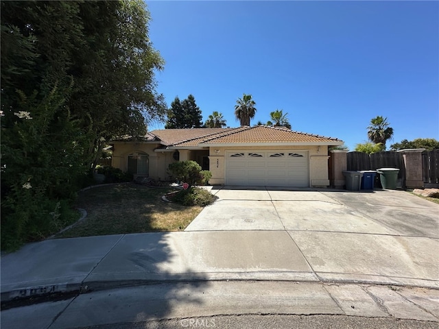 3854 Canvasback Ct, Merced, CA 95340 - mediterranean / spanish home featuring stucco siding, an attached garage, a tile roof, and concrete driveway