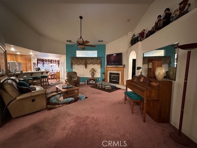 3854 Canvasback Ct, Merced, CA 95340 - living area featuring a ceiling fan, carpet floors, a tiled fireplace, and high vaulted ceiling