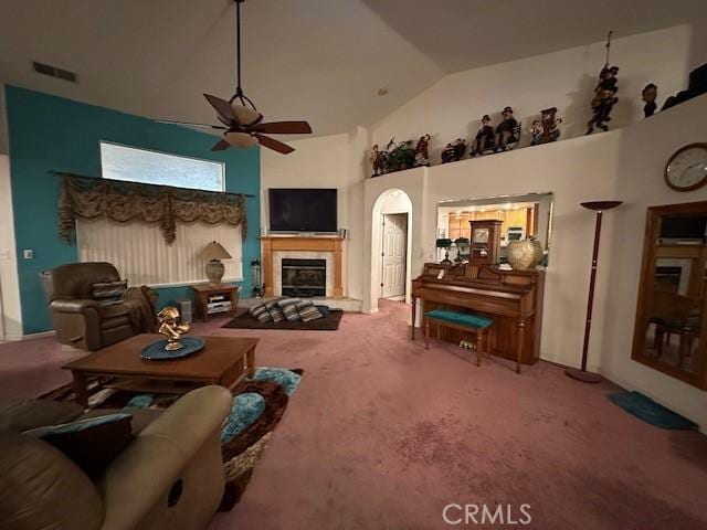 3854 Canvasback Ct, Merced, CA 95340 - carpeted living area with ceiling fan, high vaulted ceiling, a glass covered fireplace, and arched walkways
