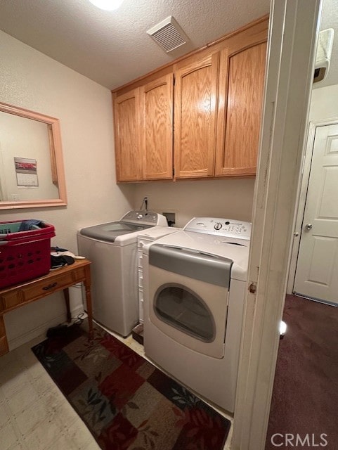 3854 Canvasback Ct, Merced, CA 95340 - laundry area featuring cabinet space, washing machine and clothes dryer, and a textured ceiling