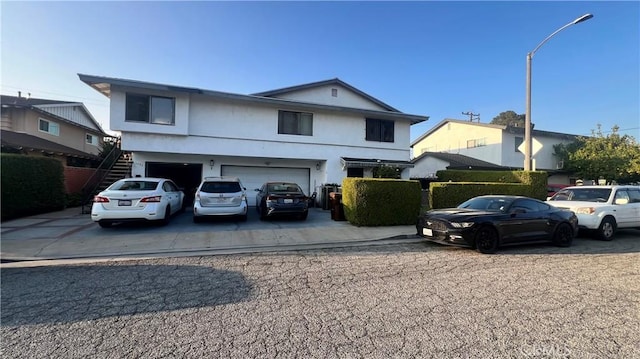 11053 Elmcrest St, El Monte, CA 91731 - traditional-style house featuring a garage, stairway, driveway, and stucco siding