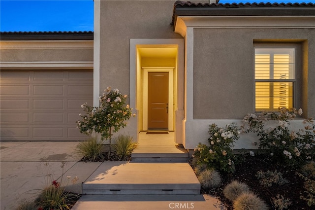 11937 Wandering Way, Corona, CA 92883 - property entrance with stucco siding, a garage, and a tile roof