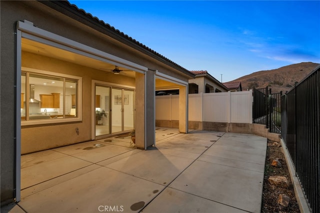 11937 Wandering Way, Corona, CA 92883 - fenced backyard with ceiling fan, a patio, and a mountain view