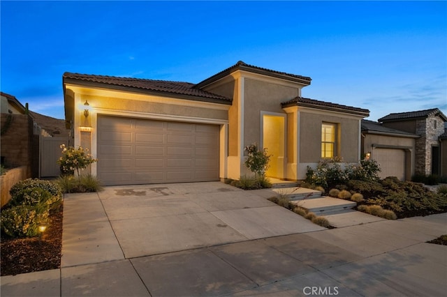 11937 Wandering Way, Corona, CA 92883 - mediterranean / spanish home with an attached garage, stucco siding, driveway, and a tile roof