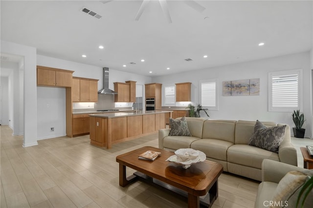 11937 Wandering Way, Corona, CA 92883 - living room featuring plenty of natural light, light wood-type flooring, recessed lighting, and ceiling fan