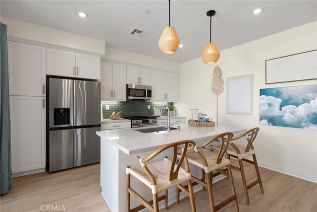 12247 Elliott Ave Unit C, El Monte, CA 91732 - kitchen featuring stainless steel appliances, light wood-style floors, tasteful backsplash, light countertops, and recessed lighting