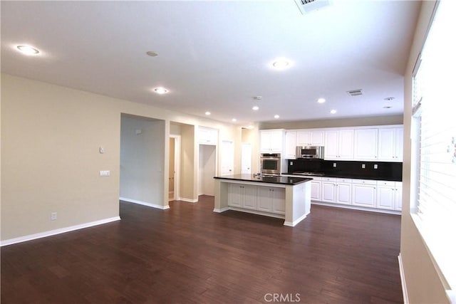629 E Gardenia Dr, Azusa, CA 91702 - kitchen featuring appliances with stainless steel finishes, dark countertops, dark wood-type flooring, and recessed lighting