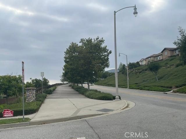 629 E Gardenia Dr, Azusa, CA 91702 - view of asphalt road featuring street lights, curbs, and sidewalks