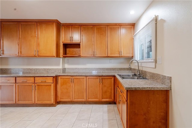 903 W 84th St, Los Angeles, CA 90044 - kitchen with brown cabinets, light stone countertops, recessed lighting, light tile patterned flooring, and open shelves