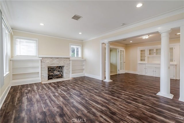 903 W 84th St, Los Angeles, CA 90044 - unfurnished living room featuring ornate columns, dark wood finished floors, crown molding, a stone fireplace, and recessed lighting