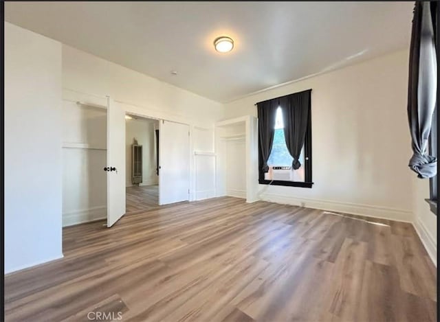 724 W 2nd St, Pomona, CA 91766 - unfurnished bedroom featuring wood finished floors and baseboards