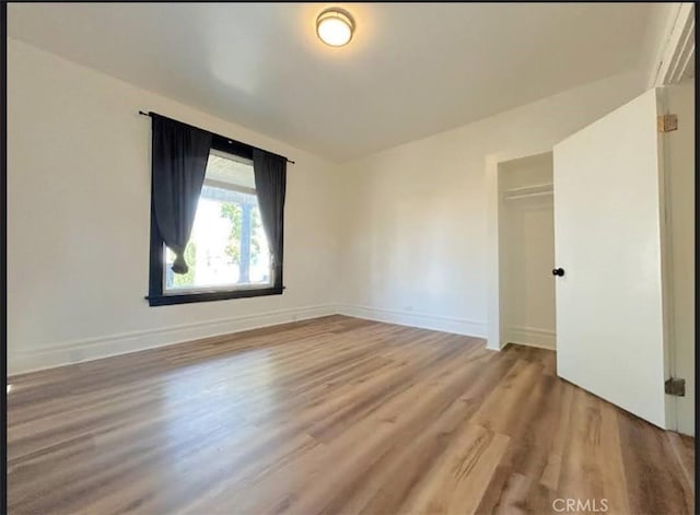 724 W 2nd St, Pomona, CA 91766 - unfurnished bedroom with wood finished floors and a closet