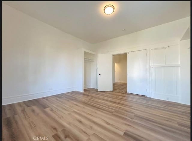 724 W 2nd St, Pomona, CA 91766 - unfurnished bedroom with light wood-type flooring and a closet