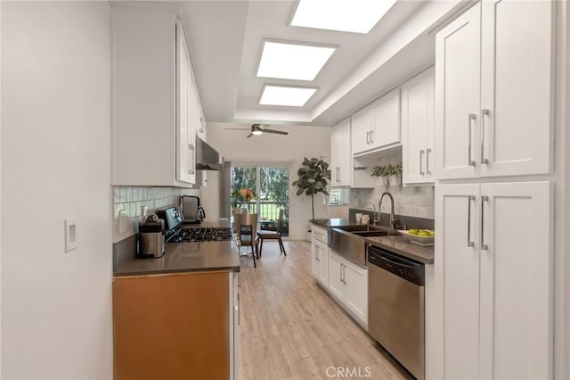 3246 Little Mountain Dr Unit D, San Bernardino, CA 92405 - kitchen featuring stainless steel appliances, dark countertops, decorative backsplash, and light wood-style floors